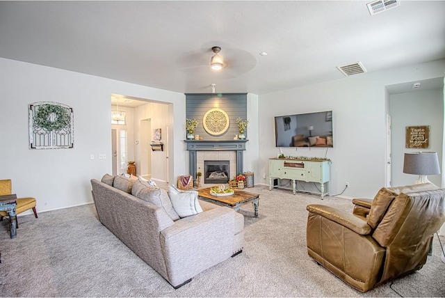 708 Ashwood Ln, Moore, OK 73160 - carpeted living room featuring ceiling fan and a tiled fireplace