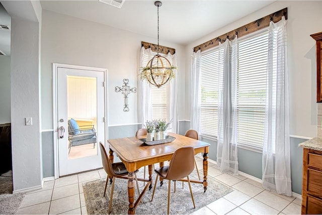 708 Ashwood Ln, Moore, OK 73160 - dining space featuring light tile patterned floors, baseboards, and a chandelier
