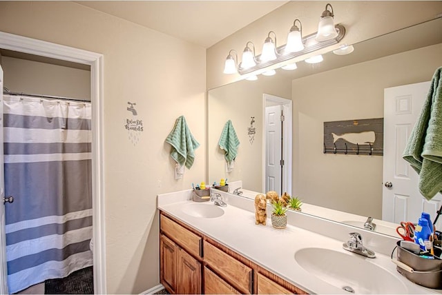 708 Ashwood Ln, Moore, OK 73160 - bathroom featuring double vanity and a shower with shower curtain
