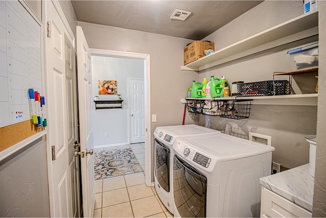 708 Ashwood Ln, Moore, OK 73160 - laundry room with washing machine and dryer and light tile patterned floors