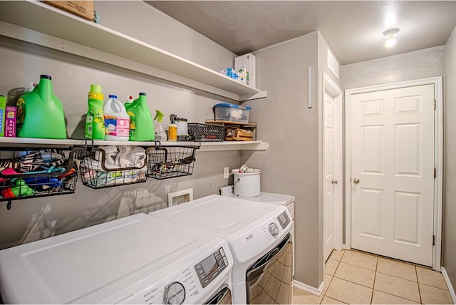 708 Ashwood Ln, Moore, OK 73160 - laundry room featuring washing machine and clothes dryer, light tile patterned flooring, and baseboards