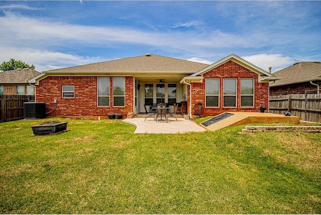 708 Ashwood Ln, Moore, OK 73160 - back of property with central air condition unit, brick siding, a patio area, and an outdoor fire pit