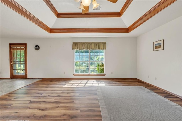 826 Stone Dr, Blanchard, OK 73010 - empty room featuring a raised ceiling, ornamental molding, wood finished floors, ceiling fan, and baseboards