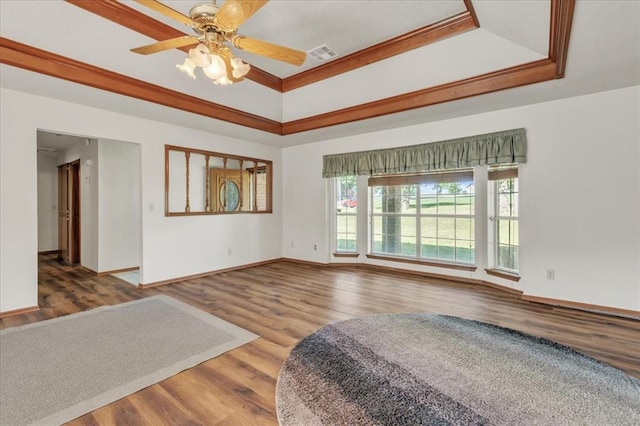 826 Stone Dr, Blanchard, OK 73010 - spare room featuring a tray ceiling, crown molding, wood finished floors, baseboards, and a ceiling fan