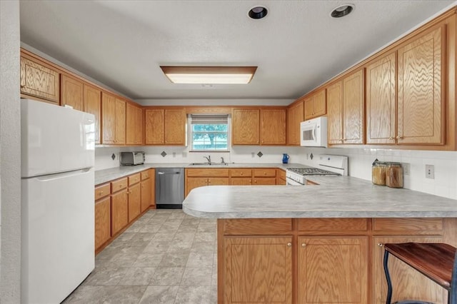 826 Stone Dr, Blanchard, OK 73010 - kitchen featuring white appliances, a peninsula, light countertops, and a sink