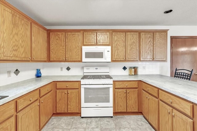 826 Stone Dr, Blanchard, OK 73010 - kitchen featuring white appliances, backsplash, light countertops, and brown cabinetry