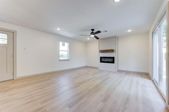737 NW 89th St, Oklahoma City, OK 73114 - unfurnished living room with light wood-type flooring, a large fireplace, recessed lighting, baseboards, and a ceiling fan