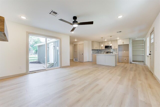 737 NW 89th St, Oklahoma City, OK 73114 - unfurnished living room featuring light wood-style floors, recessed lighting, ceiling fan, and baseboards
