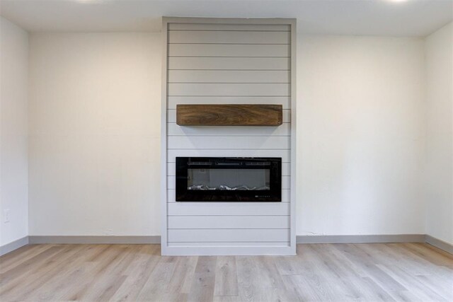 737 NW 89th St, Oklahoma City, OK 73114 - detailed view of wood finished floors, baseboards, and a fireplace