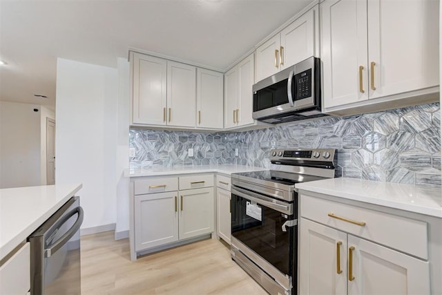 737 NW 89th St, Oklahoma City, OK 73114 - kitchen featuring appliances with stainless steel finishes, light countertops, light wood-style floors, and decorative backsplash