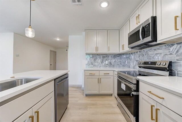 737 NW 89th St, Oklahoma City, OK 73114 - kitchen with appliances with stainless steel finishes, light countertops, light wood-type flooring, backsplash, and recessed lighting