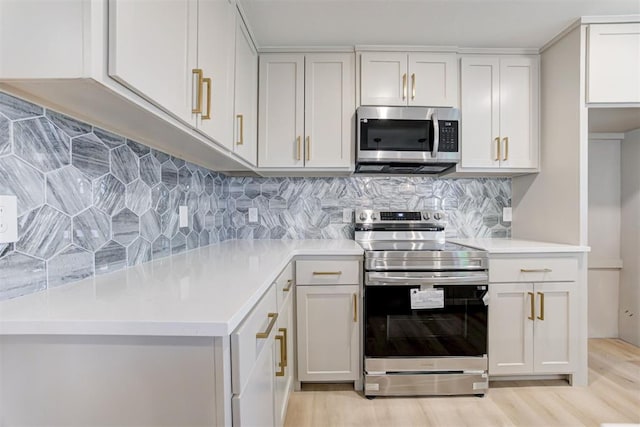 737 NW 89th St, Oklahoma City, OK 73114 - kitchen featuring stainless steel appliances, light wood-style flooring, light countertops, and decorative backsplash