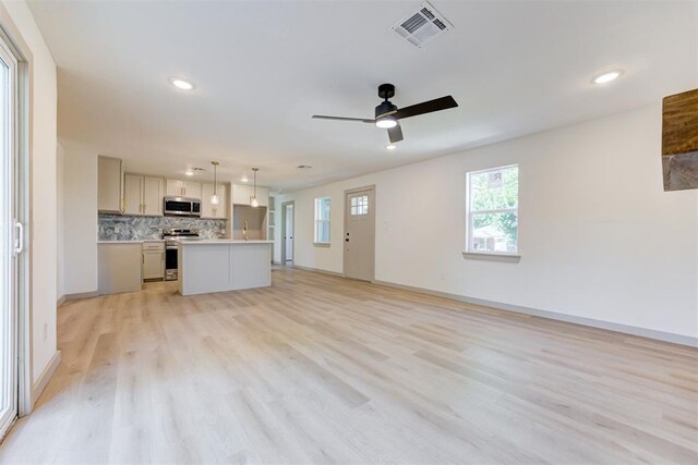 737 NW 89th St, Oklahoma City, OK 73114 - unfurnished living room featuring recessed lighting, light wood-style flooring, a ceiling fan, and baseboards