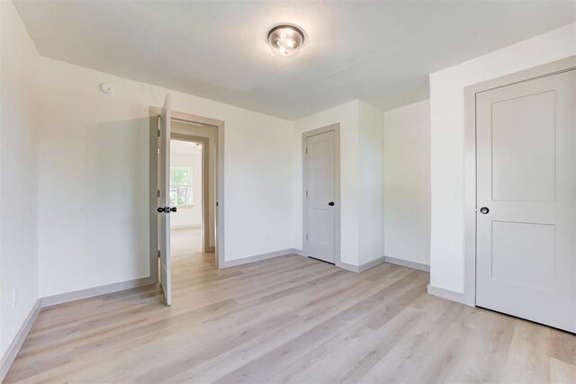 737 NW 89th St, Oklahoma City, OK 73114 - unfurnished bedroom with light wood finished floors and baseboards