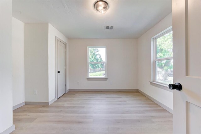 737 NW 89th St, Oklahoma City, OK 73114 - empty room with plenty of natural light, light wood-style floors, and baseboards