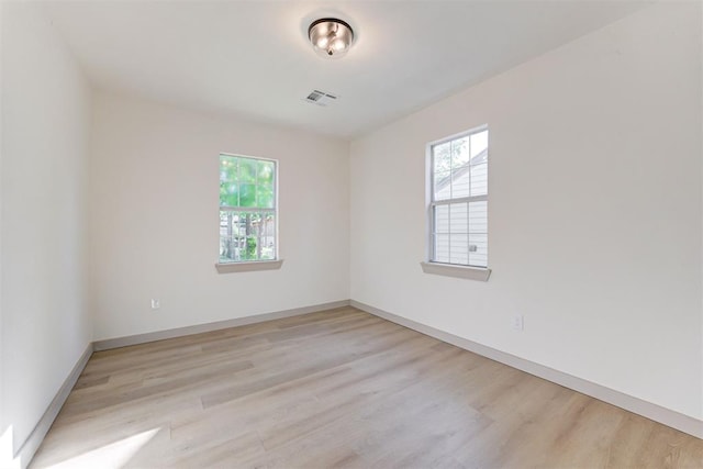 737 NW 89th St, Oklahoma City, OK 73114 - empty room featuring plenty of natural light, light wood finished floors, and baseboards
