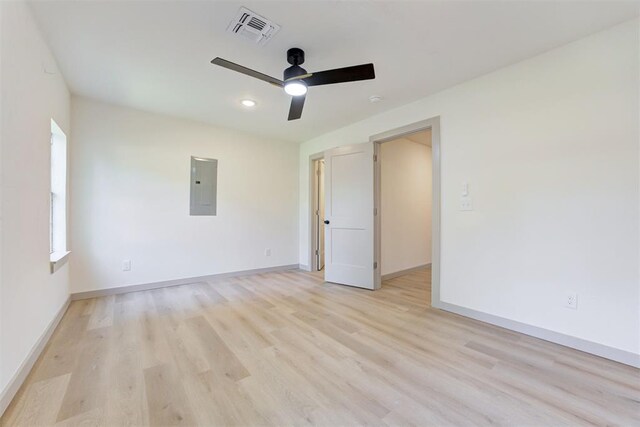 737 NW 89th St, Oklahoma City, OK 73114 - spare room featuring electric panel, a ceiling fan, light wood-type flooring, baseboards, and recessed lighting