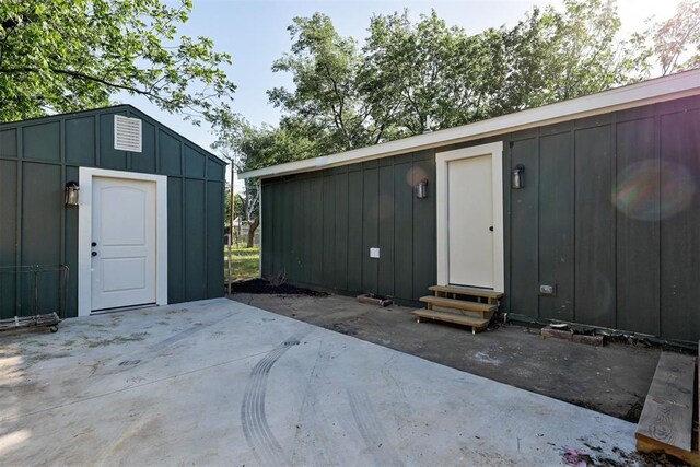 737 NW 89th St, Oklahoma City, OK 73114 - entrance to property with a patio and board and batten siding