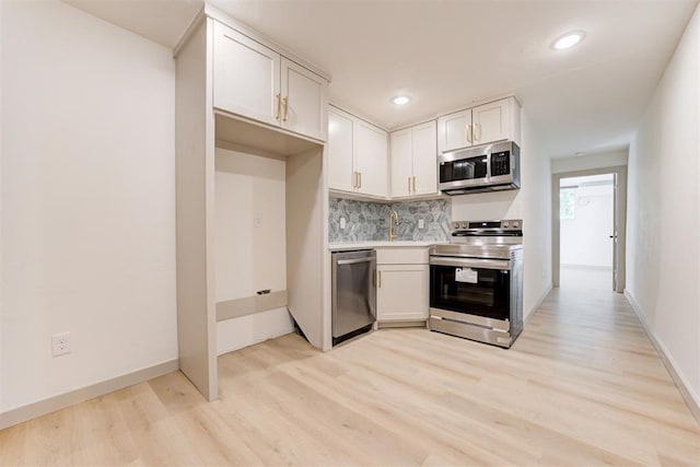 737 NW 89th St, Oklahoma City, OK 73114 - kitchen featuring stainless steel appliances, light wood-style floors, tasteful backsplash, light countertops, and white cabinetry