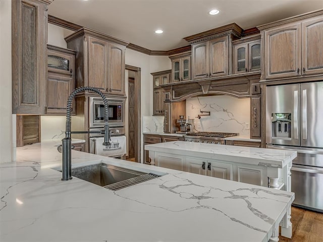 4401 Cannon Dr, Norman, OK 73072 - kitchen featuring appliances with stainless steel finishes, glass insert cabinets, ornamental molding, backsplash, and recessed lighting