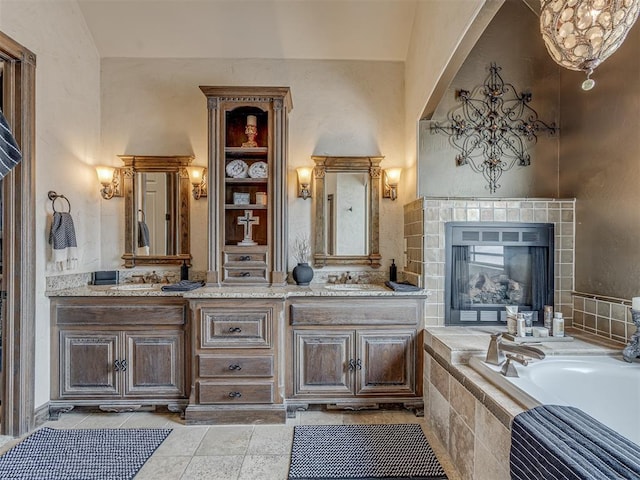 4401 Cannon Dr, Norman, OK 73072 - bathroom with double vanity, a bath, and a fireplace