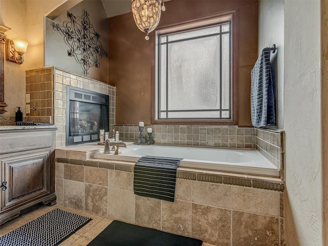 4401 Cannon Dr, Norman, OK 73072 - bathroom with a bath, a textured wall, vanity, and a fireplace
