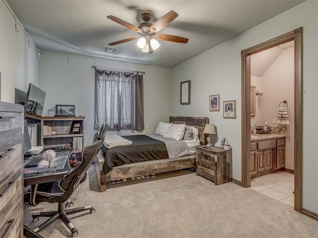 4401 Cannon Dr, Norman, OK 73072 - bedroom with light carpet, a desk, connected bathroom, ceiling fan, and light tile patterned floors