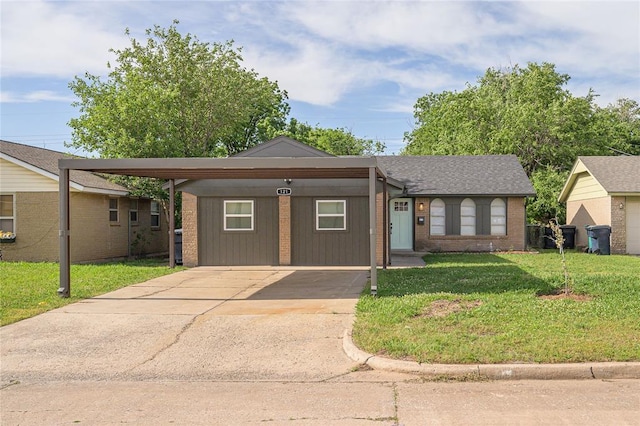 121 NW 79th St, Oklahoma City, OK 73114 - ranch-style house featuring concrete driveway, a front lawn, brick siding, and a carport