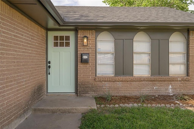121 NW 79th St, Oklahoma City, OK 73114 - doorway to property featuring a shingled roof and brick siding