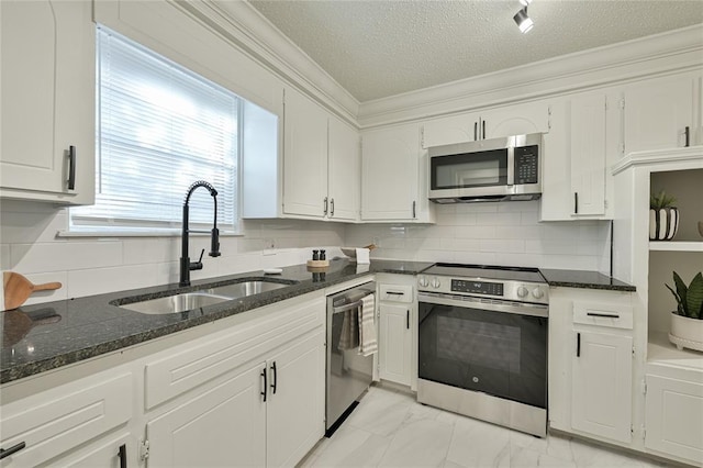 121 NW 79th St, Oklahoma City, OK 73114 - kitchen with stainless steel appliances, a sink, white cabinets, a textured ceiling, and crown molding