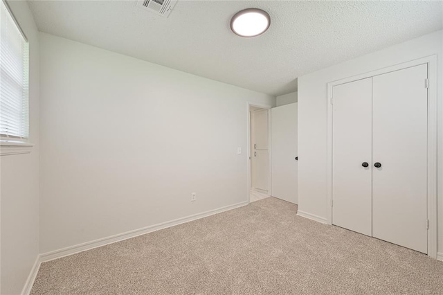 121 NW 79th St, Oklahoma City, OK 73114 - unfurnished bedroom featuring light carpet, a closet, and baseboards