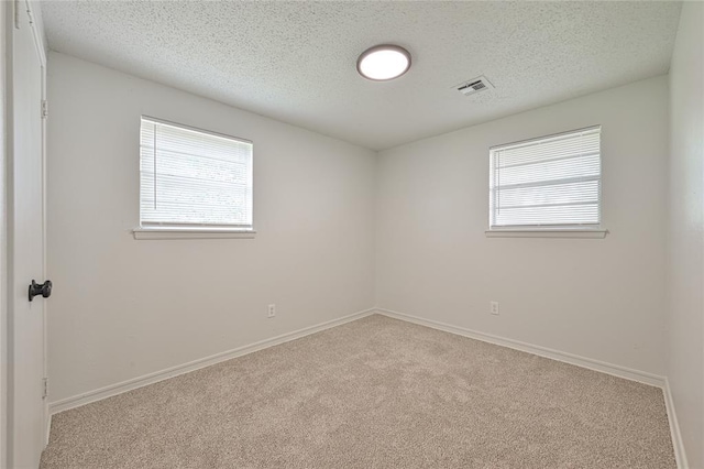 121 NW 79th St, Oklahoma City, OK 73114 - unfurnished room featuring carpet floors, a textured ceiling, and baseboards