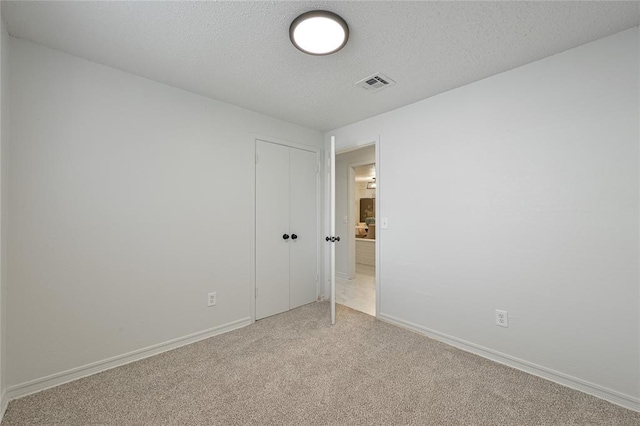 121 NW 79th St, Oklahoma City, OK 73114 - unfurnished bedroom featuring light colored carpet, a textured ceiling, a closet, and baseboards