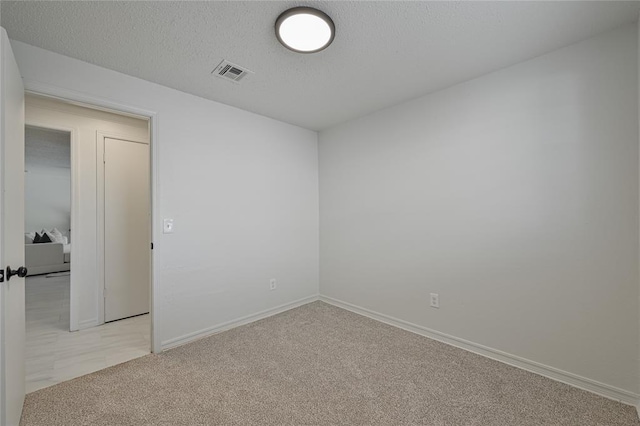 121 NW 79th St, Oklahoma City, OK 73114 - empty room featuring light colored carpet, baseboards, and a textured ceiling
