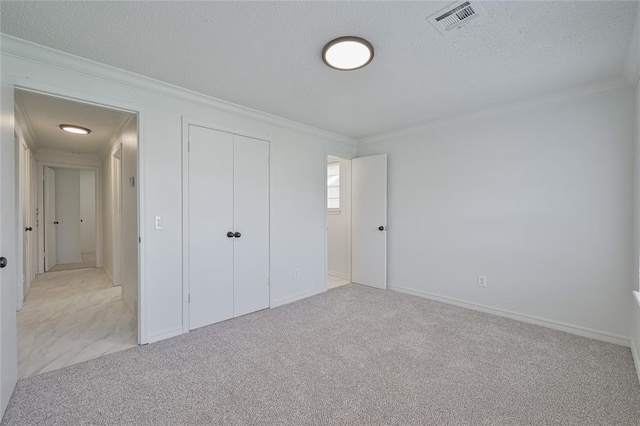 121 NW 79th St, Oklahoma City, OK 73114 - unfurnished bedroom with crown molding, carpet, a textured ceiling, and a closet