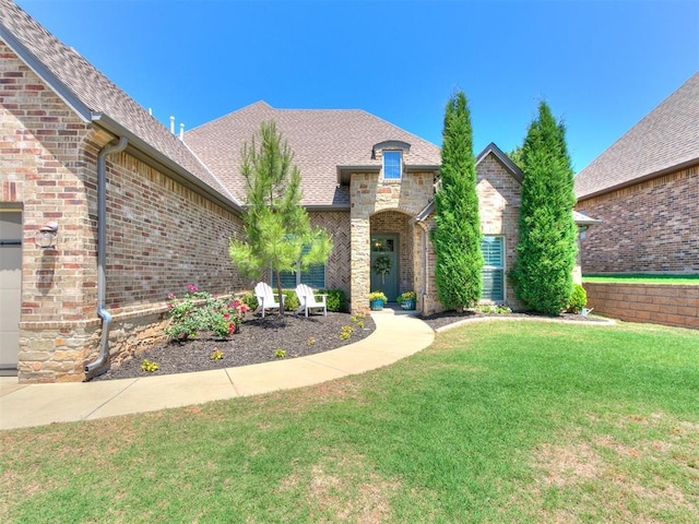 4133 Carmina Dr, Edmond, OK 73034 - view of front facade with brick siding, a front lawn, and roof with shingles