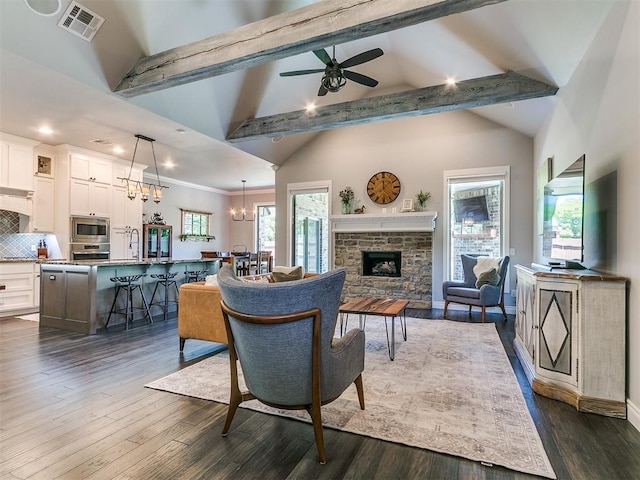 4133 Carmina Dr, Edmond, OK 73034 - living room featuring recessed lighting, dark wood-type flooring, a chandelier, a fireplace, and a ceiling fan
