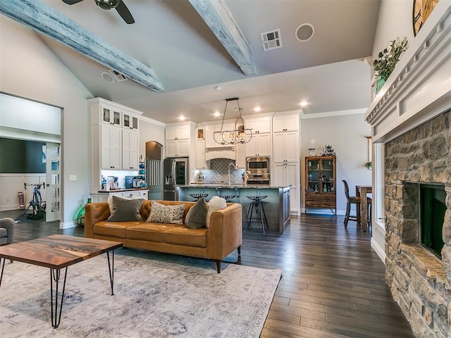 4133 Carmina Dr, Edmond, OK 73034 - living area featuring recessed lighting, dark wood-type flooring, a stone fireplace, crown molding, and ceiling fan