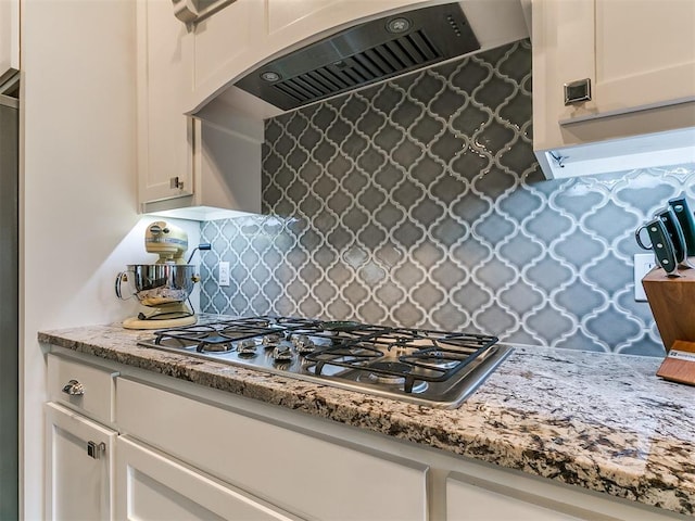 4133 Carmina Dr, Edmond, OK 73034 - kitchen featuring range hood, tasteful backsplash, stainless steel gas cooktop, light stone countertops, and white cabinets