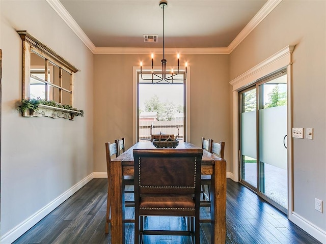 4133 Carmina Dr, Edmond, OK 73034 - dining area featuring healthy amount of natural light, a chandelier, dark wood-type flooring, crown molding, and baseboards