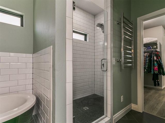4133 Carmina Dr, Edmond, OK 73034 - full bath featuring a shower stall, a bath, radiator, a walk in closet, and baseboards