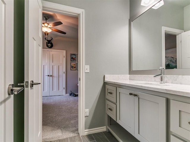4133 Carmina Dr, Edmond, OK 73034 - bathroom featuring vanity, a ceiling fan, and baseboards