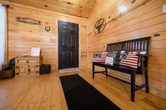 47 Sockeye Rd, Broken Bow, OK 74728 - foyer with wooden walls, lofted ceiling, and hardwood / wood-style flooring