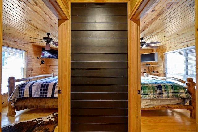 47 Sockeye Rd, Broken Bow, OK 74728 - bedroom with wood walls, multiple windows, wood finished floors, and wooden ceiling