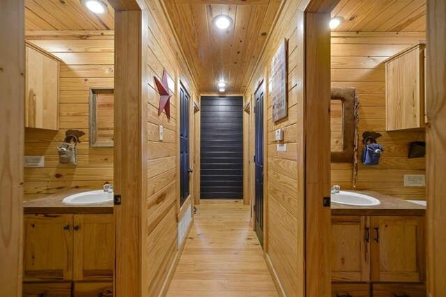 47 Sockeye Rd, Broken Bow, OK 74728 - hallway featuring wooden walls, light wood finished floors, a sink, wood ceiling, and recessed lighting