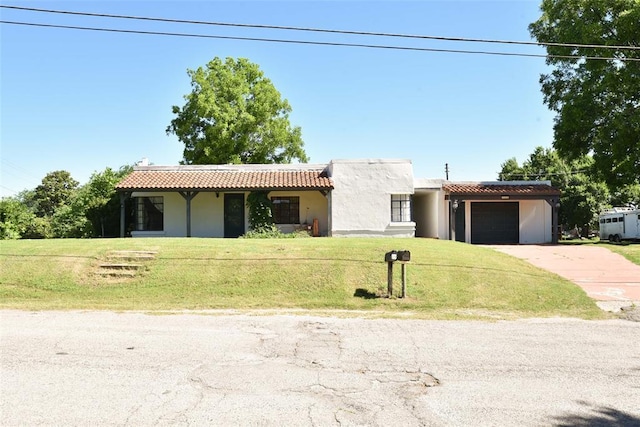 723 W Leslie St, Pauls Valley, OK 73075 - view of front of home featuring a tiled roof, an attached garage, and stucco siding