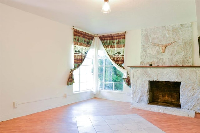 723 W Leslie St, Pauls Valley, OK 73075 - unfurnished living room with wood finished floors, baseboards, and a stone fireplace