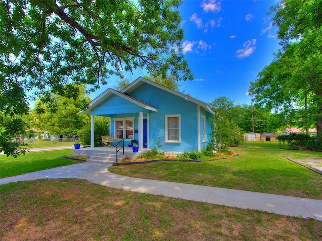 bungalow-style house featuring a porch and a front yard