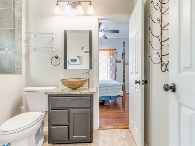 bathroom with ensuite bath, ceiling fan, toilet, and vanity