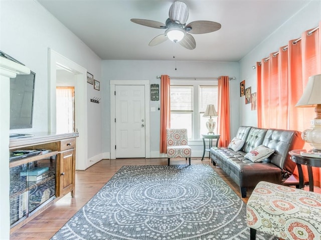 living room featuring wood finished floors and a ceiling fan